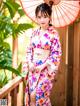 A woman in a kimono holding an umbrella.